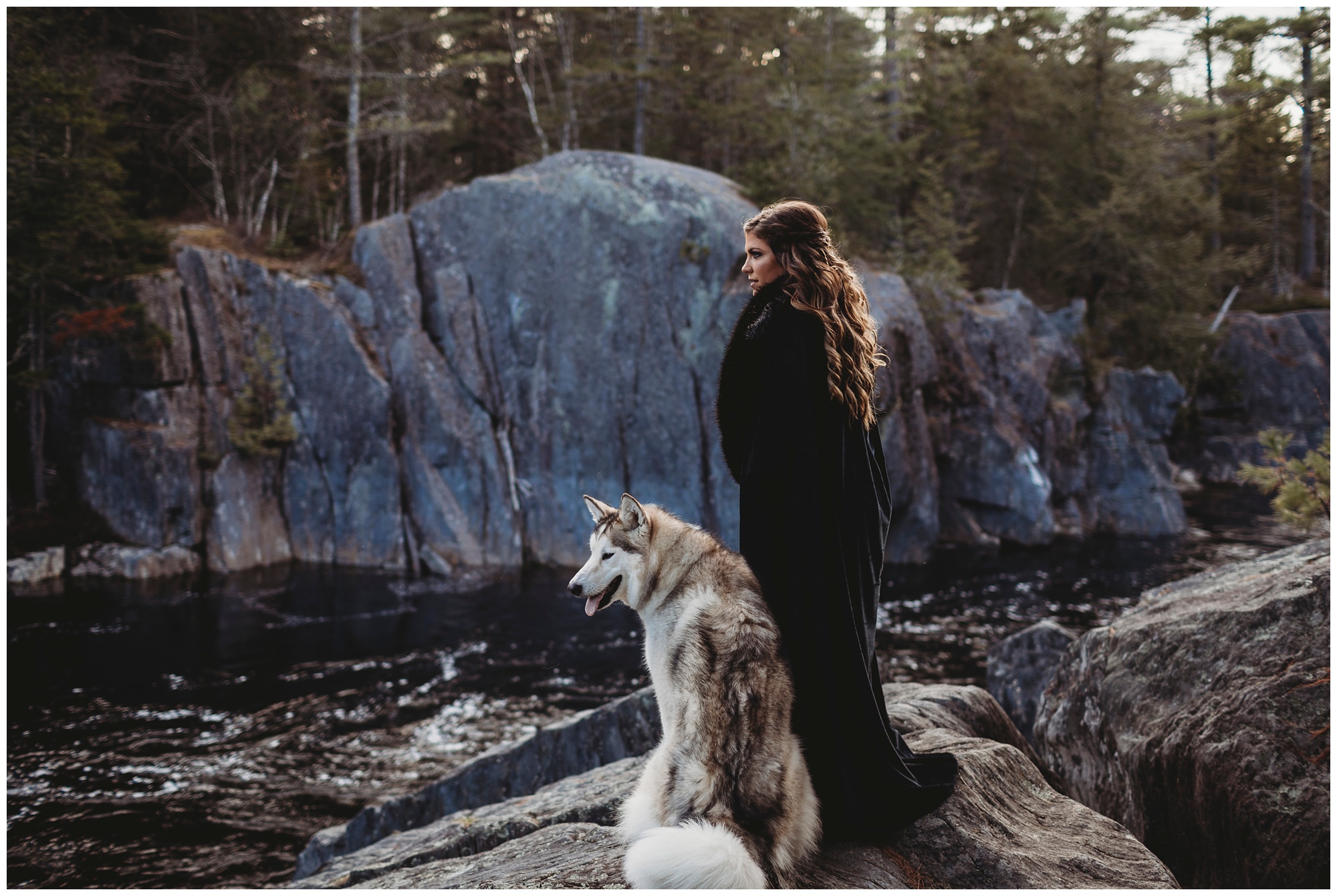 girl with dog on rock