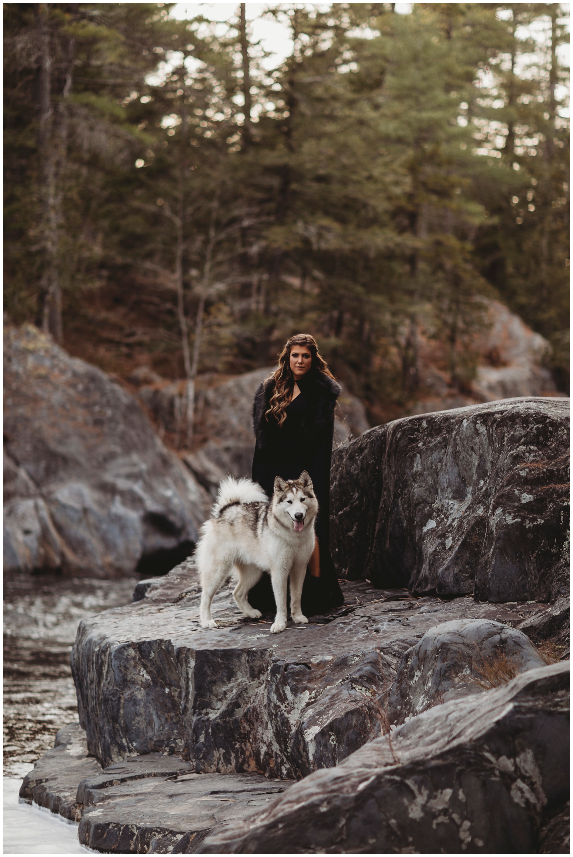 girl on cliff with husky